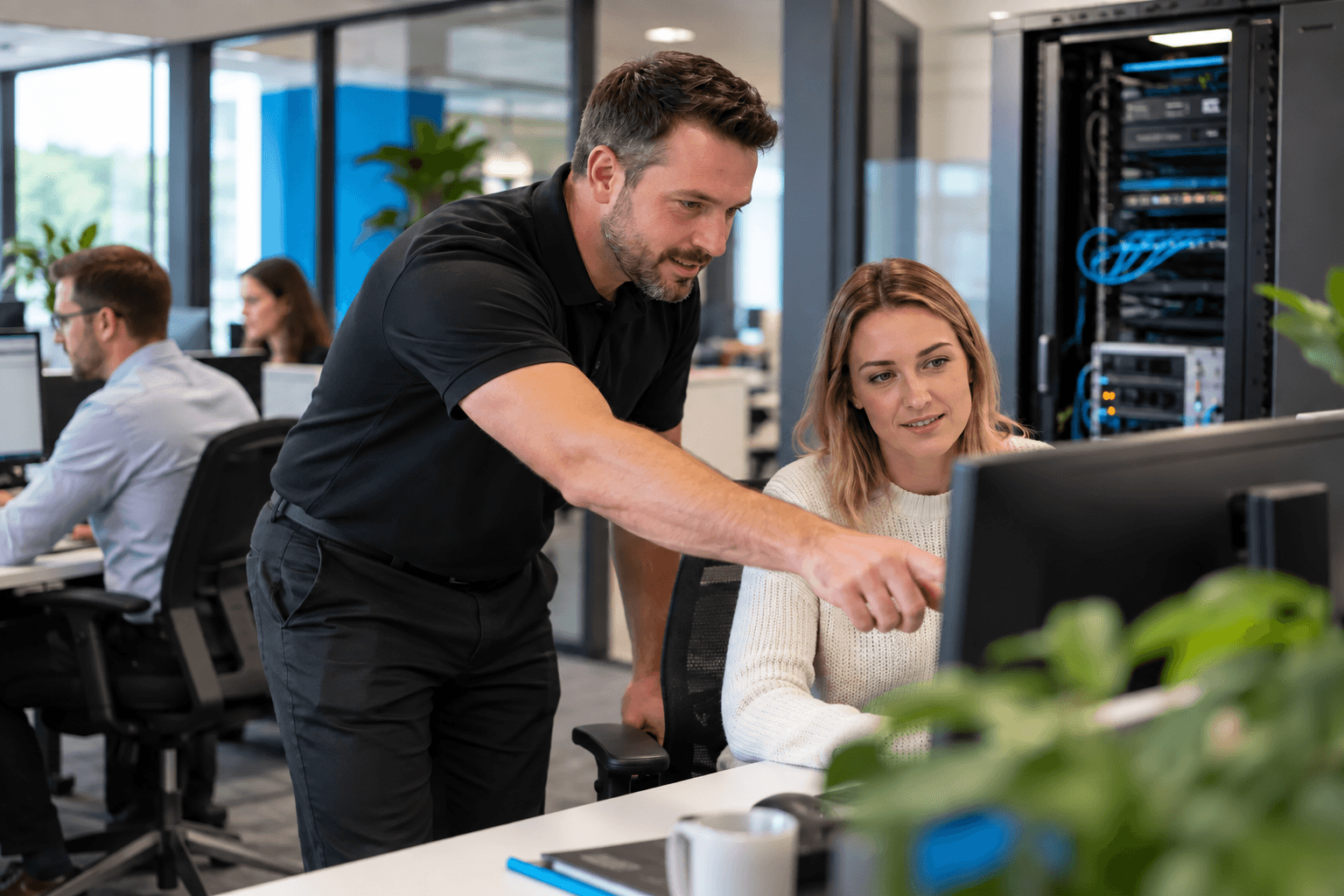 A local IT engineer helping a member of staff